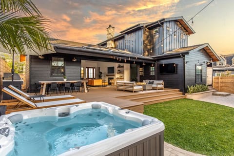 Imagine spending time with your family in this gorgeous backyard.  Hot tub, outdoor shower, sun loungers + umbrella, natural gas grill, dining table for 8, outdoor living room with TV and fire table, and outdoor games.