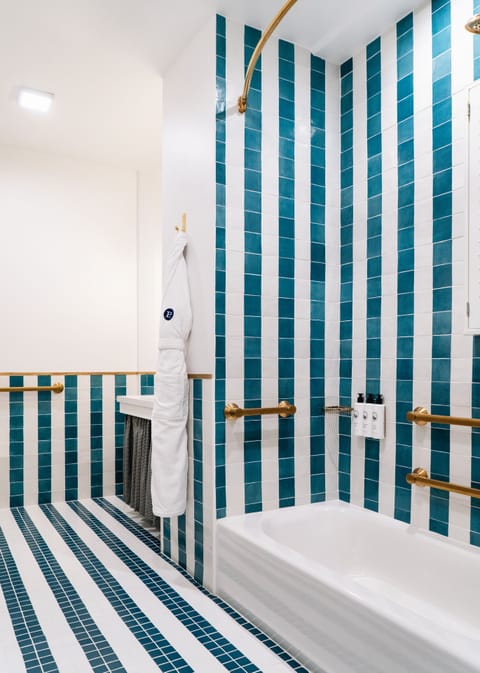 Basic Room, 1 Queen Bed, Accessible (The Queen ADA) | Bathroom | Rainfall showerhead, designer toiletries, hair dryer, bathrobes