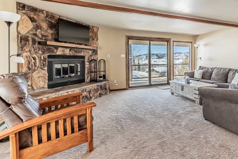 Gather in the airy living area, where large doors open to the patio and fresh mountain air.