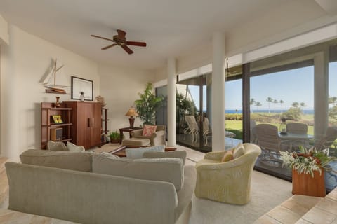 Living room looking out to lanai and ocean.  The TV is in the cabinet.