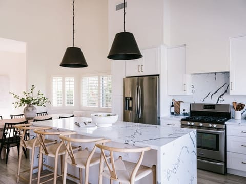Modern kitchen with sleek appliances and organic-modern design.