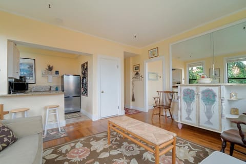 Living Area with AC surrounded by windows, enters natural sunlight. Large, fully stocked kitchenette. 2 seater bar counter
