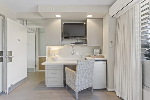 View of desk area w/ TV from bed area.