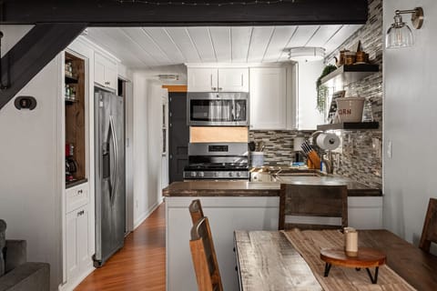 Cozy, modern cabin kitchen with warm wood accents, and an inviting dining space.