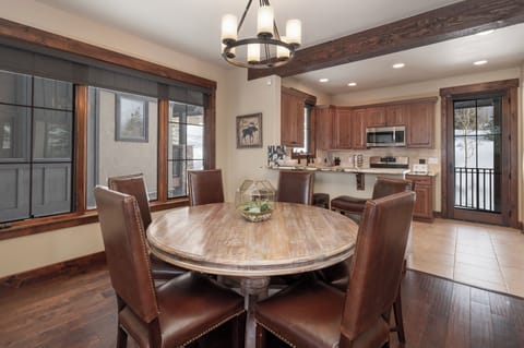 Gather around your rustic dining table for memorable meals with loved ones in this warm, wood-accented space.