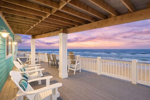 Covered beachfront deck with outdoor seating and panoramic views of the Gulf of Mexico