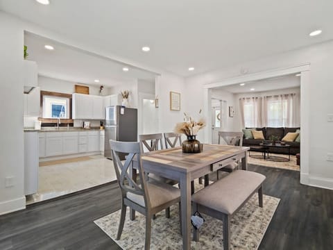 Dining area with wood table, bench, and modern chairs   - Bright open layout connected to the kitchen and living   - Ideal for shared meals with family or friends