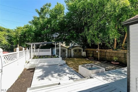 Backyard deck area w/ firepit & pergola, perfect for outdoor gatherings