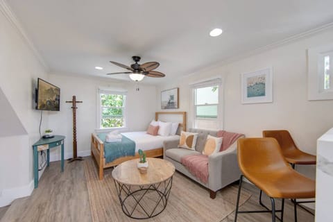 Kick back in and relax in this living/sleeping combo with a couch, queen-sized bed, and TV in Unit C.