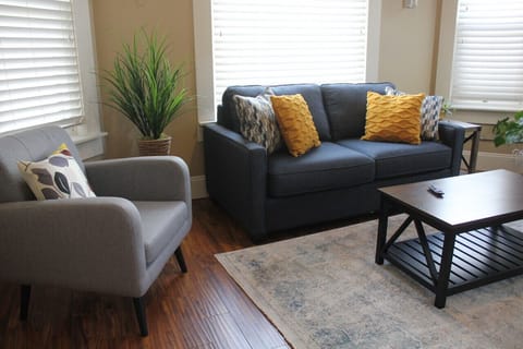 Step into a haven of comfort and warmth in our short-term rental's cozy living room, bathed in natural light.