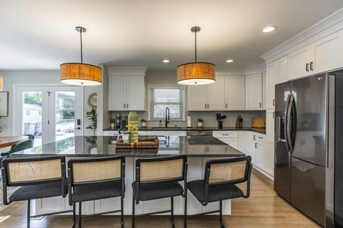 Gather around large kitchen island with seating for 4