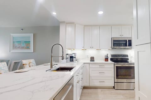 Fully Equipped Kitchen with Quartz Countertops and Stainless Appliances