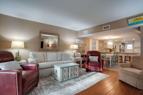 Open-concept living area with comfortable seating and a coastal-inspired coffee table.