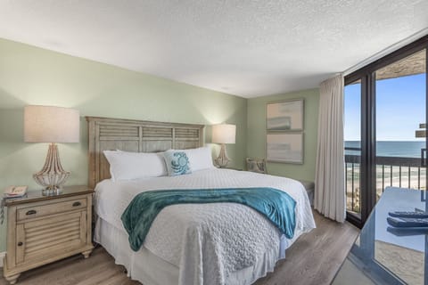 Primary bedroom with King bed, balcony access, Gulf views, TV, and private bath