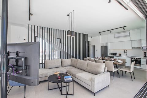 Living room wtih comfortable seating areas and widescreen TV