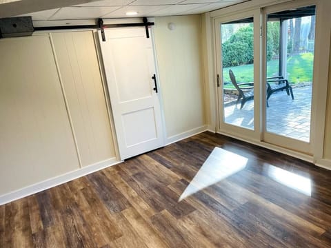Basement access to the back yard through the sliding door, and access to the laundry room through the barn door.