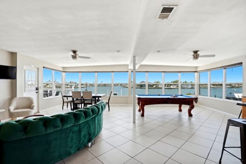 Welcome to Sunburst Vacation Rentals!  The living/dining room/kitchen are open concept and the wall of windows give a 180 degree view of the blue waters of the intracoastal of Indian Rocks Beach!  Play pool while you watch dolphins play!