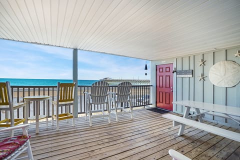 Relax on your private oceanfront deck with stunning sea views, cozy seating, and direct beach access just steps away.