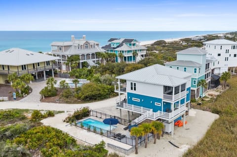 Coastal vacation rental community featuring beachfront homes with private pools and direct beach access.