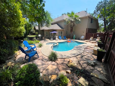 Enjoy relaxing in our tranquil backyard pool with lush landscaping and hot tub.