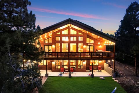 Chalet with Upper & Lower Decks, Warm Evening Lighting, and Forest Views