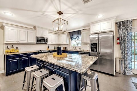 Fully equipped kitchen for all your culinary needs, featuring ample seating for dining or casual enjoyment. Complimentary spices and coffee are thoughtfully provided for your convenience.
