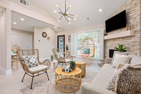 A warm, inviting space with plush seating and a cozy entertainment corner