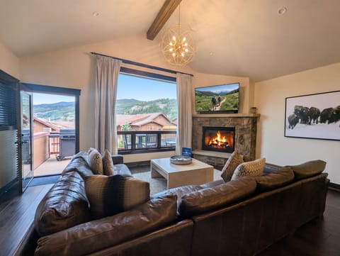 Sink into plush leather sofas beside the crackling fireplace and let mountain views through floor-to-ceiling windows frame your perfect mountain getaway.