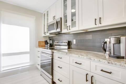 Guests love the black backsplash with contrasting brand new white cabinets