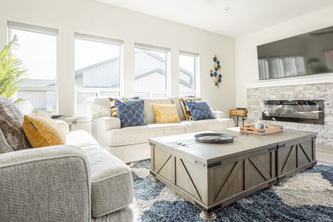 Living room features board games, electric fireplace and 70" Smart TV with cable