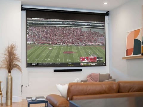 Enjoy cinema nights on a 120″ projector screen with a rich soundbar—perfect for movies or game day.