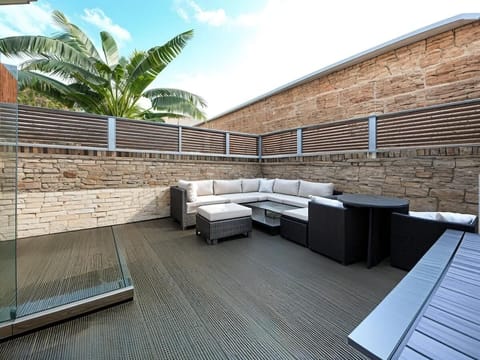 Private decked patio with comfortable seating and space to relax outdoors.