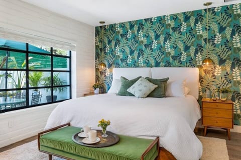 King size bed with Custom "sit up in bed" headboard cushions.
Operable windows,  lighting/phone outlets at bedside tables.  View of private gated terrace