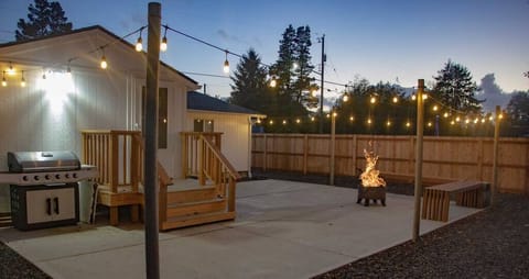 Spacious back patio with bench seating & fire pit