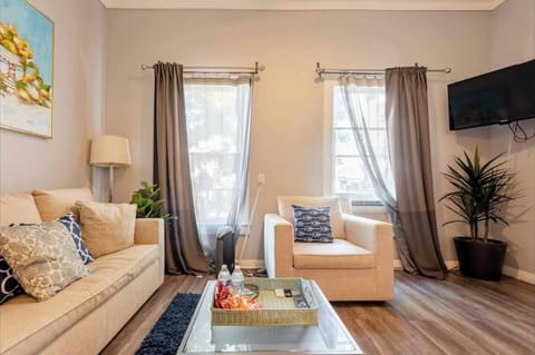 The living room area  includes (1) sofa bed and (1) futon as well as a ROKU Smart TV