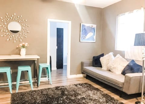 The living room area  includes (1) sofa bed and (1) futon as well as a ROKU Smart TV