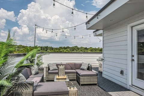 The rooftop oasis has it all—ample seating, BBQ grill, gas fire pit, cornhole boards, and space to relax
