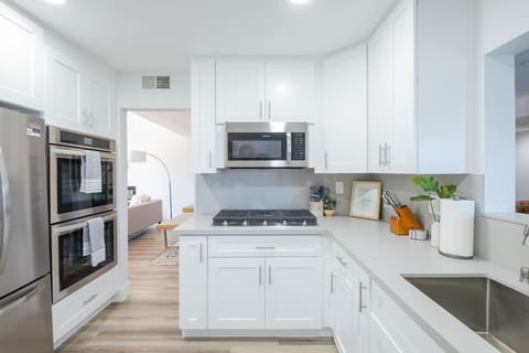 The chef-friendly kitchen features double ovens, a French door fridge and quality cookware