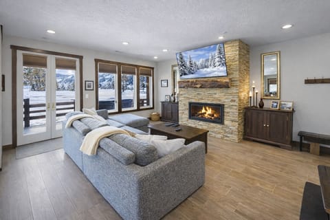 Unwind by the stunning stone fireplace after a day outdoors. Watch TV or enjoy the views from the cozy living room.