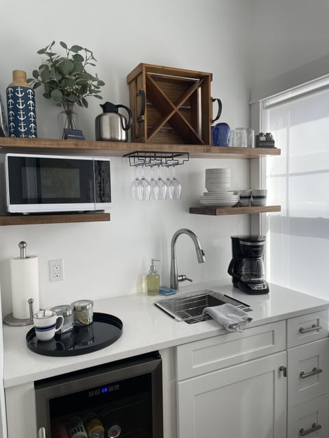 Upstairs kitchenette, coffee maker, beverage fridge, microwave, sink