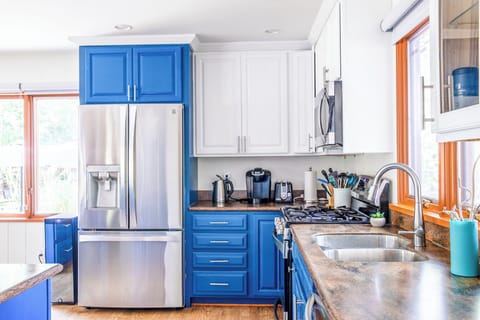 Sleek kitchen cabinetry subtly reflects the water outside, blending beauty with nature.