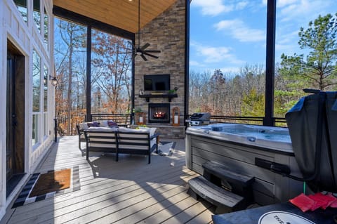 Outdoor Oasis: Expansive deck with fireplace, hot tub, and stunning forest views—your retreat awaits!