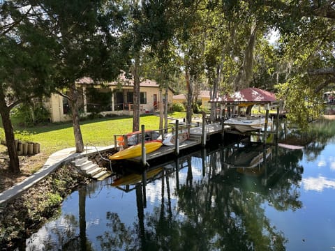 view of dock, kayaks, boat on lift

