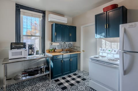 Full kitchen with large fridge, oven, toaster oven and microwave