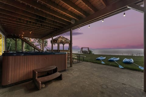 Enjoy the ambiance of the hot tub, Tiki Bar, String Lights and Kayaks