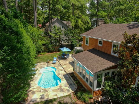 The backyard oasis is truly one-of-a-kind w/ pool, patio, dining area, and grill