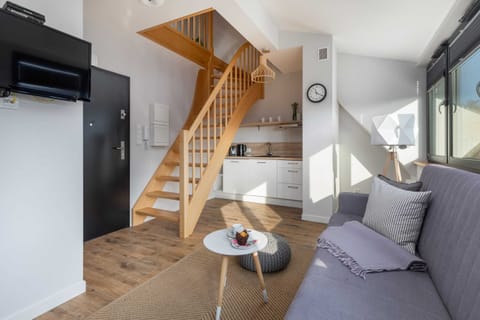 A wide view of the staircase and the open-plan living room.