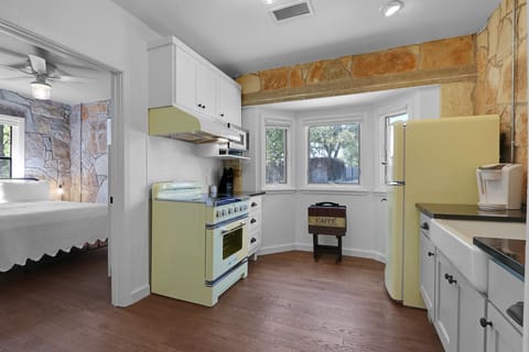 Walking from the living room into the full kitchen