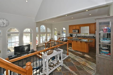 Foyer overlooks the open floor plan of the kitchen, dining, and living spaces