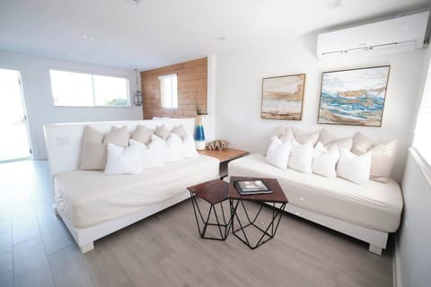 Unwind on the plush sofas, catch up on your favorite shows on the smart TV, or simply bask in the natural light that floods this inviting space. 